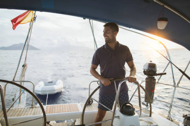 istock Smiling young man enjoy sailing 2137723322