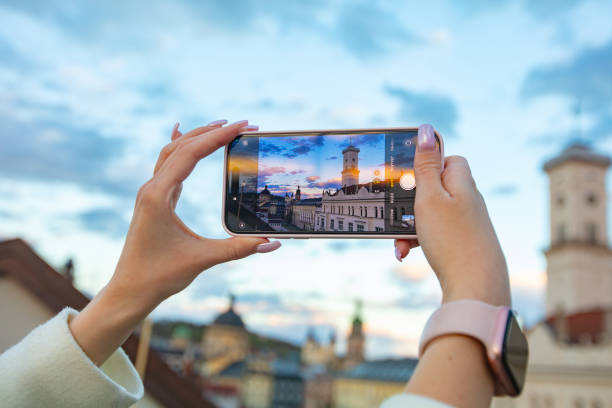 istock Female hands holding smartphone and making photos in Lviv 2137729517