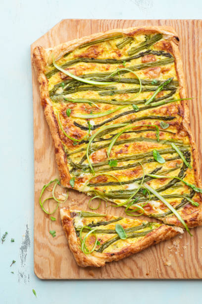 istock Asparagus pie or tart with eggs, cheese and aromatic herbs, spring Easter recipes. French healthy cuisine, Provencal herbs. Spring asparagus 2137729521