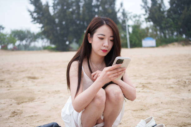 istock woman looking at mobile phone 2137729529