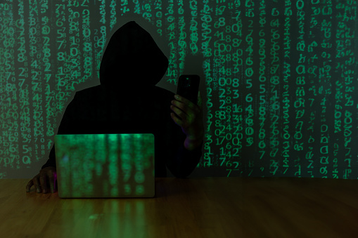 Hacker using cell phone for hacking