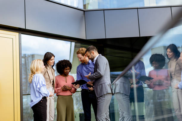 istock Business Professionals Engaging in a Strategy Discussion Outside a Modern Office Building 2137793846