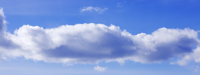 single, small, white cloud on blue sky background