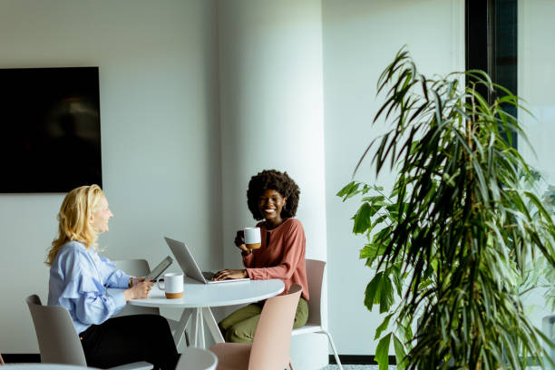 istock Joyful Office Coffee Break With Colleagues Sharing a Laugh in Bright Workspace 2137800138