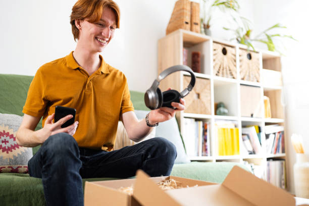 istock Young man unpacking his online order 2137811624
