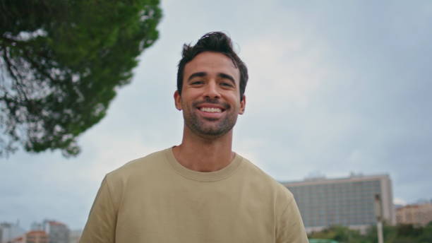 istock Portrait smiling man urban park. Happy hispanic guy posing at tree greenery 2137813273