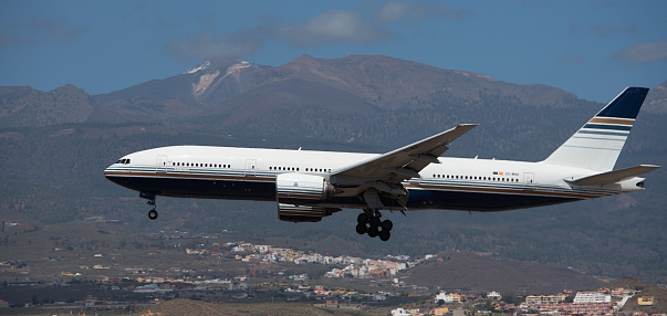Tenerife, Spain March 30st, 2024. Boeing 777-212(ER) Privilege Style Airlines flies in the blue sky. Landing at Tenerife Airport. El Teide volcano in the background