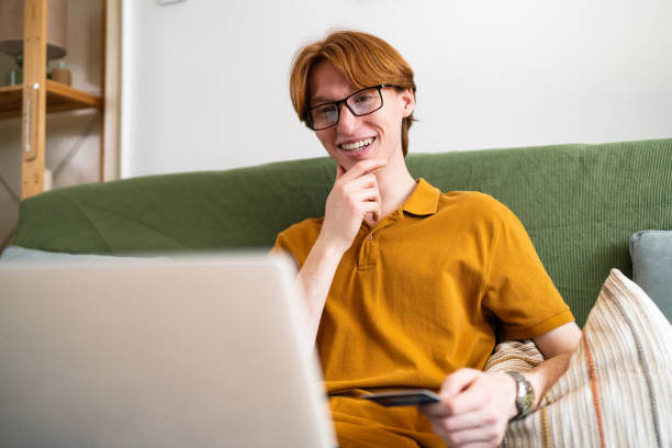 istock Young man shopping online from his home 2137822194