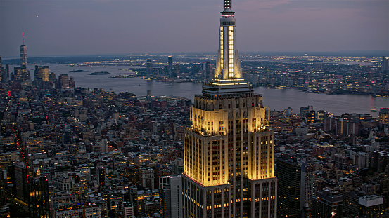 Manhattan, New York / U.S. - July 14, 2023: Aerial view of Empire State Building surrounding with Midtown Manhattan in New York City, New York State, USA.