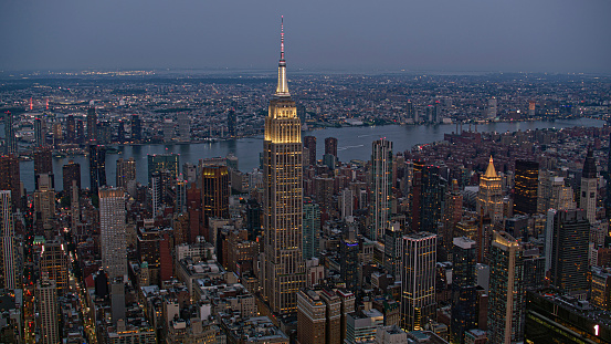 Manhattan, New York / U.S. - July 14, 2023: Aerial view of Empire State Building surrounding with Midtown Manhattan in New York City, New York State, USA.