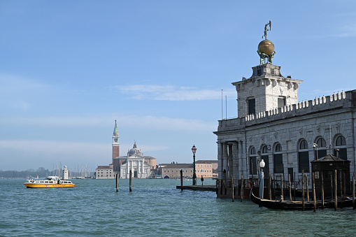 Venice, Italy, march 12, 2024 : Pinault Foundation of the Punta della Dogana in Venice with the Basilica of San Giorgio Maggiore in the background