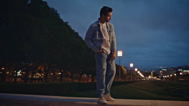 istock Stylish man relaxing evening town park illuminated street lights. Guy walking 2137833607