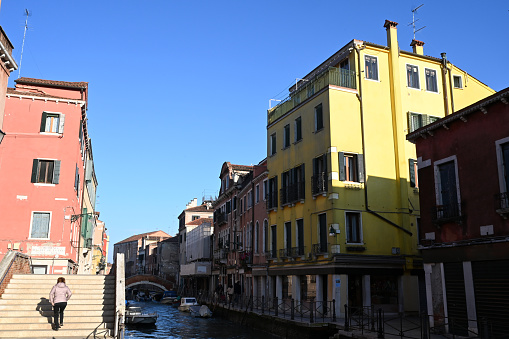 Venice, Italy, march 12, 2024 : Yellow house lining a canal in Venice