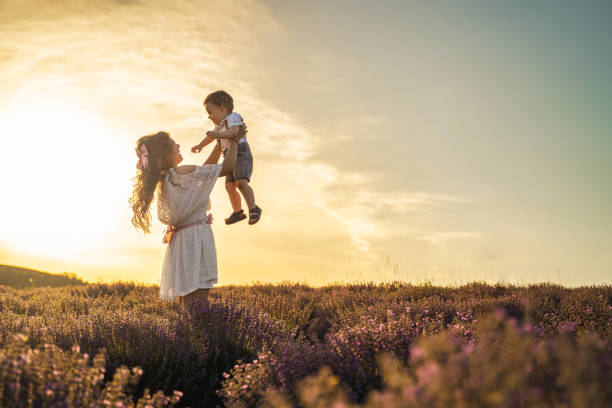 istock Mother and her son having fun in lavender field at sunset 2137846648