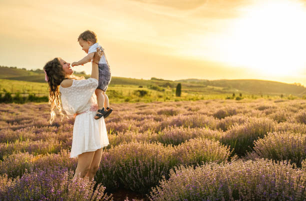 istock Mother and her son having fun in lavender field at sunset 2137852920