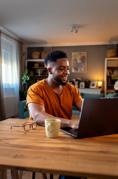 istock Young African American man sitting at home using laptop for video call. 2137866505