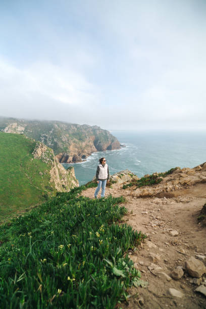 istock Woman looking at the ocean view from a cliff 2137899919