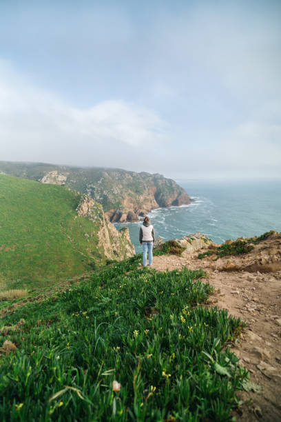 istock Woman looking at the ocean view from a cliff 2137909881