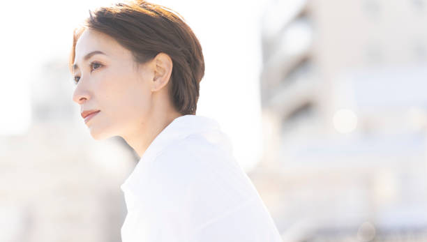 istock An Asian woman refreshing on the rooftop. 2137921965