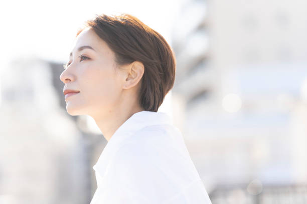 istock An Asian woman refreshing on the rooftop. 2137921966