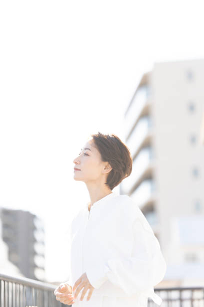 istock An Asian woman refreshing on the rooftop. 2137921967