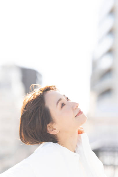 istock An Asian woman refreshing on the rooftop. 2137921969
