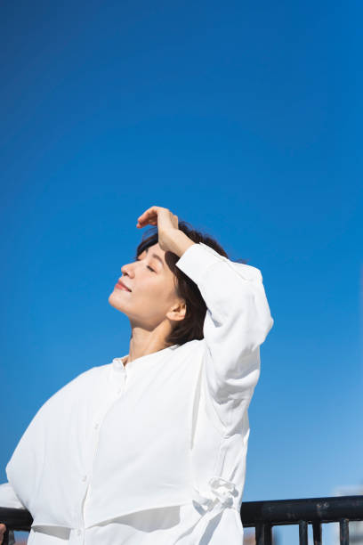 istock A middle-aged woman and the blue sky. 2137921977