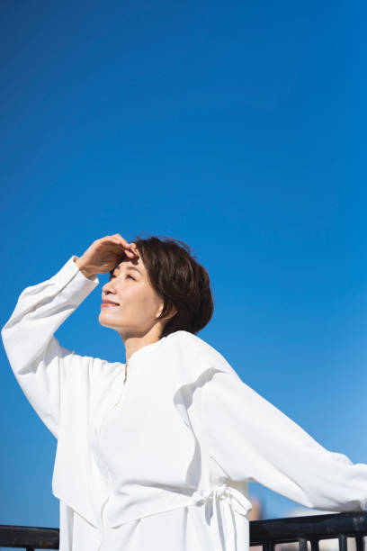 istock A middle-aged woman and the blue sky. 2137921979