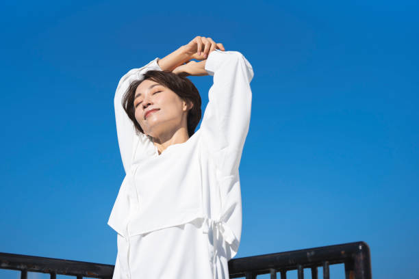 istock A middle-aged woman and the blue sky. 2137922487