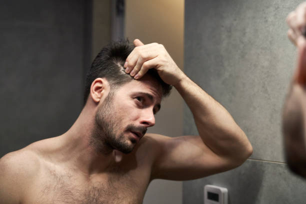 istock Caucasian man checking hair condition in the bathroom 2137930954