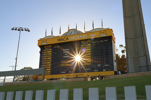 Cricket scoreboard at the Western Australian Cricket Association (WACA) ground, Perth, Western Australia. Sun star, lens flare.