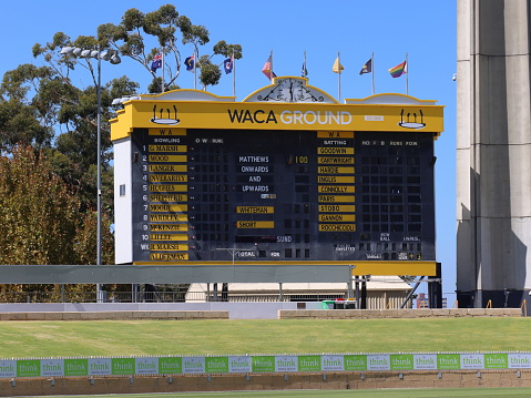 Cricket scoreboard at the Western Australian Cricket Association (WACA) ground, Perth, Western Australia. Green grass banks.