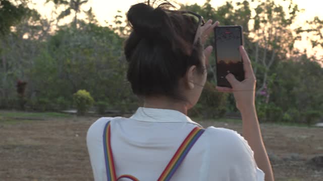 Tourist photographing Ratu Boko Temple, yogyakarta with smartphone