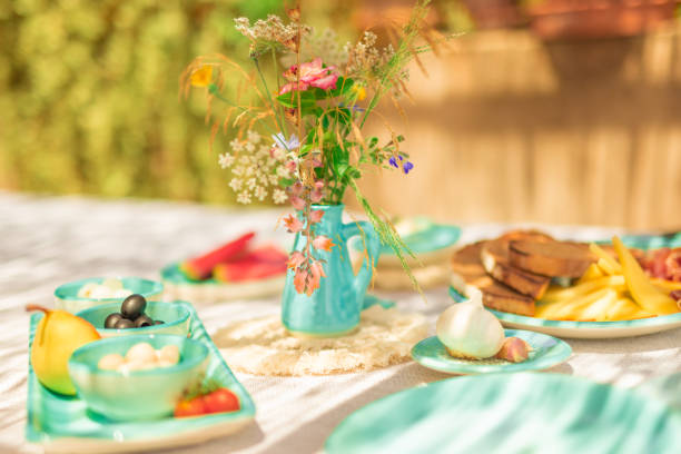 Breakfast table with a Mallorcan theme, including typical turquoise tableware and Pa amb oli. Some over exposing because of the sunlight.