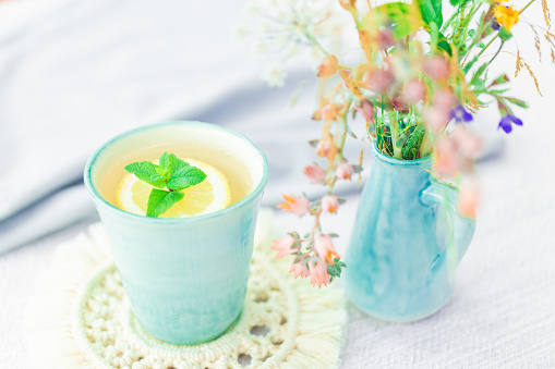 Butterfly pea blue pea flower herbal tea in a glass cup for healthy drinking on grey concrete background.