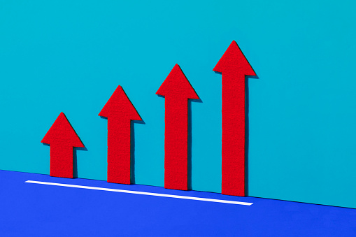 Line graph with red arrows moving upwards on blue background