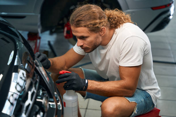 istock Young man is detailing a black car 2138021760