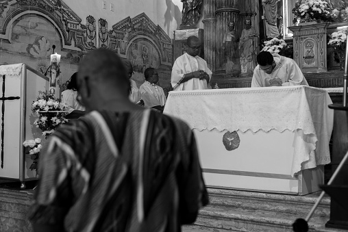 Salvador, Bahia, Brazil - May 12, 2019: Catholic and Candomble faithful are seen during mass at the Rosario dos Pretos church in Pelourinho. City of Salvador, Bahia.