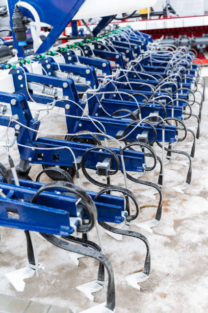 istock Electric blue tractors line up in snowcovered field 2138025566