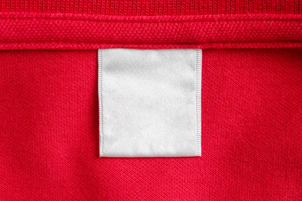istock Blank white laundry care clothes label on red shirt fabric texture background 2138038722