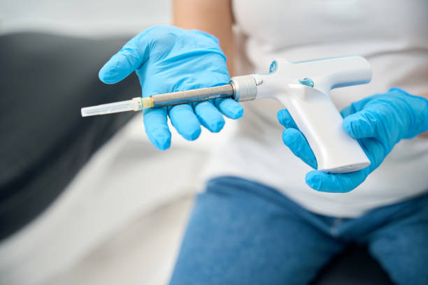 istock Dentist assistant showing a special gun for filling root canals 2138071292