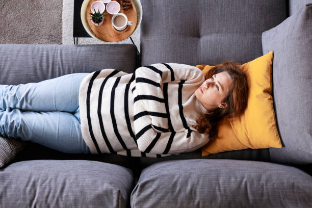 istock Top view depressed young woman lying on sofa 2138131487