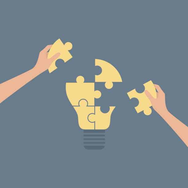 istock Two hands placing missing pieces on puzzle in the shape of a lamp. Vector illustration in flat style 2138136464