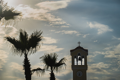 Palm trees and church tower with a bell in Athens. High quality photo