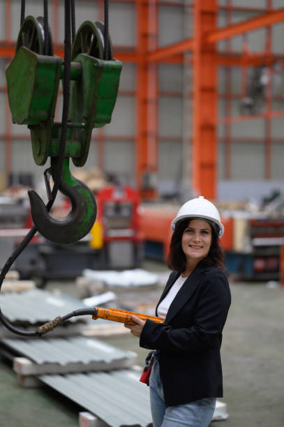 istock Female worker or technician working on tablet and checking mechanical equipment in factory 2138168740