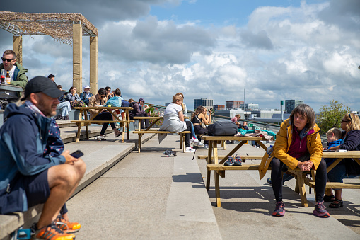 Amsterdam, Netherlands—Jul 30, 2023:visitors enjoying sunshine at the NEMO Science Museum terrace