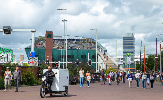 Amsterdam, Netherlands—Jul 30, 2023: tourists with NEMO Science Museum terrace in the background