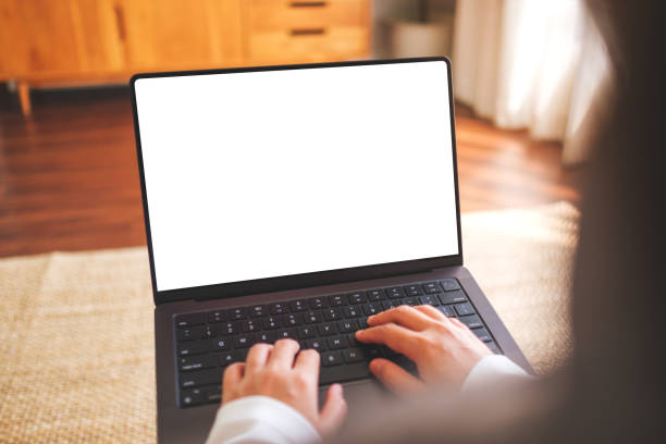 istock Mockup image of a woman working and typing on laptop computer with blank white desktop screen at home 2138189379