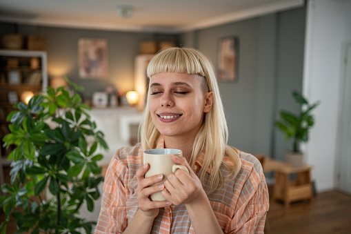 Young hipster culture woman drinking morning coffee at home