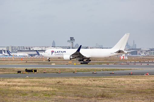 Frankfurt, Germany - February 20, 2024: A cargo airplane Boeing 767-300F of airline LATAM taxiing on the runway of Frankfurt Airport. Frankfurt International Airport is the largest airport in Germany. LATAM Airlines is a Chilean multinational airline.